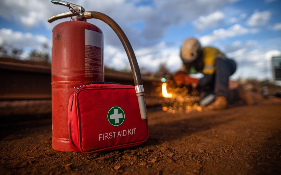 Safe workplace red First Aid Kit together with fire extinguisher