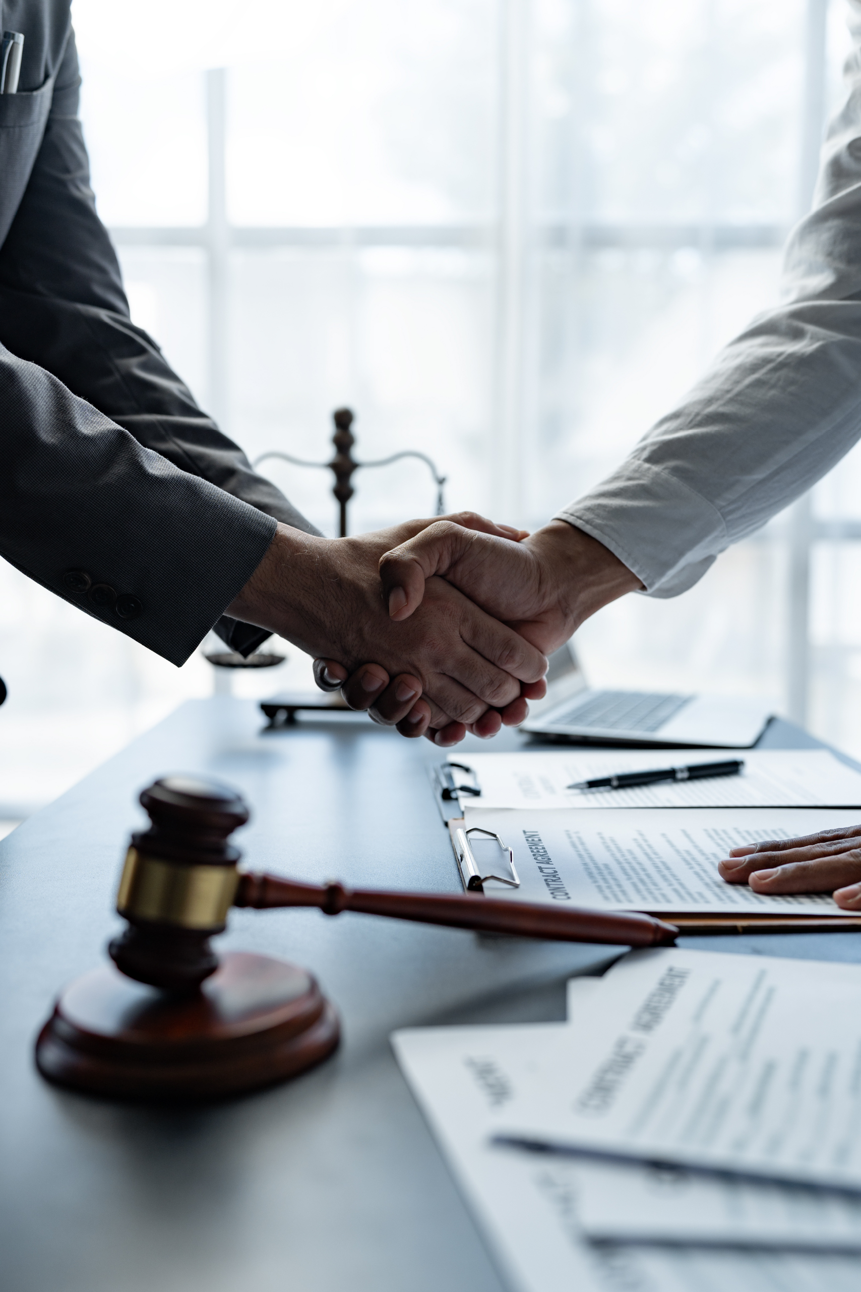 A lawyer shaking a client's hand