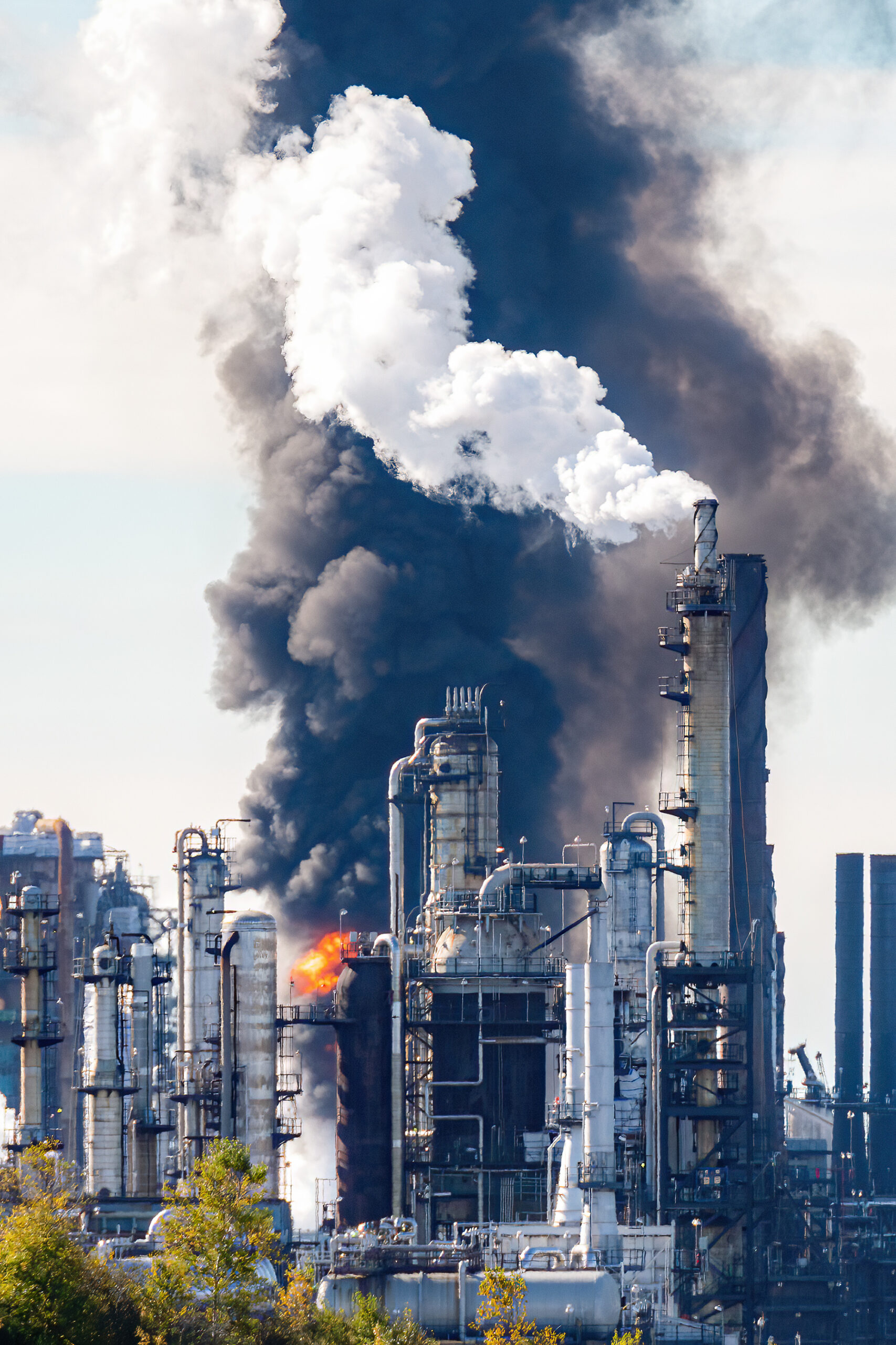 A cloud of smoke and an explosion at an oil refinery