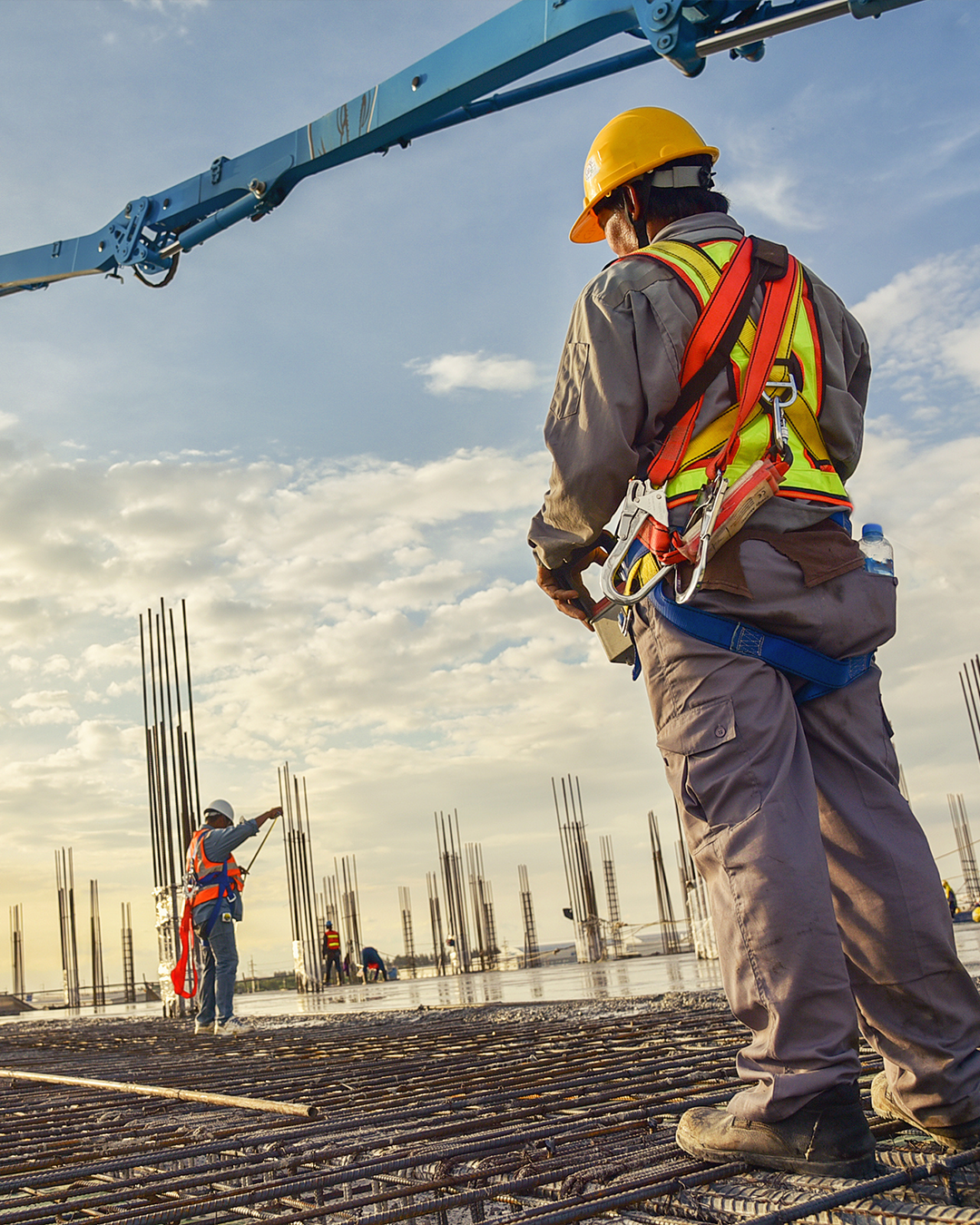 a contractor standing outside looking in the distance to another contractor