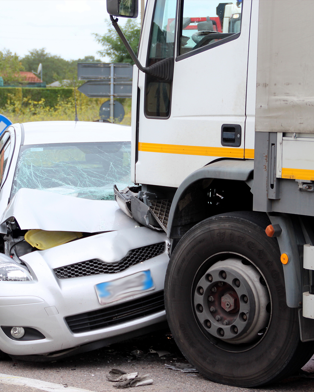 an 18-wheeler truck accident with a small car. the small car has damage to the front of the vehicle