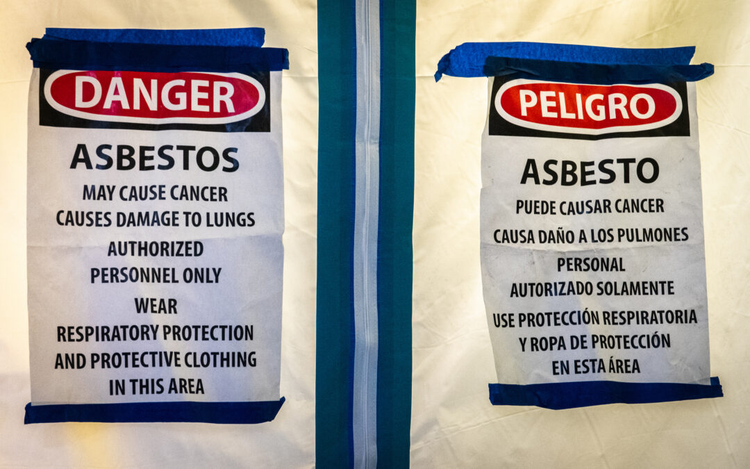 Warning signs for Asbestos. Sign reads: Danger. Asbestos. May Cause Cancer. Causes Damage to Lungs. Authorized Personnel Only. Wear Respiratory Protection And Protective Clothing In This Area.