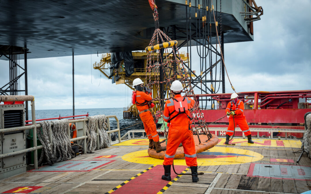 oil rig workers handling equipment