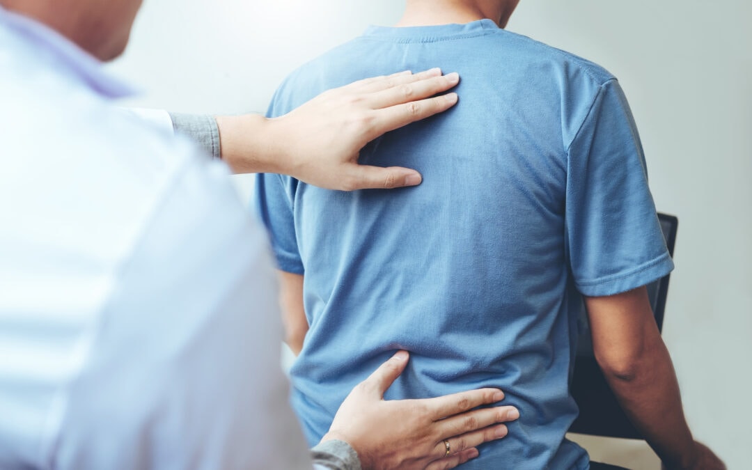 Doctor consulting with patient for back problems
