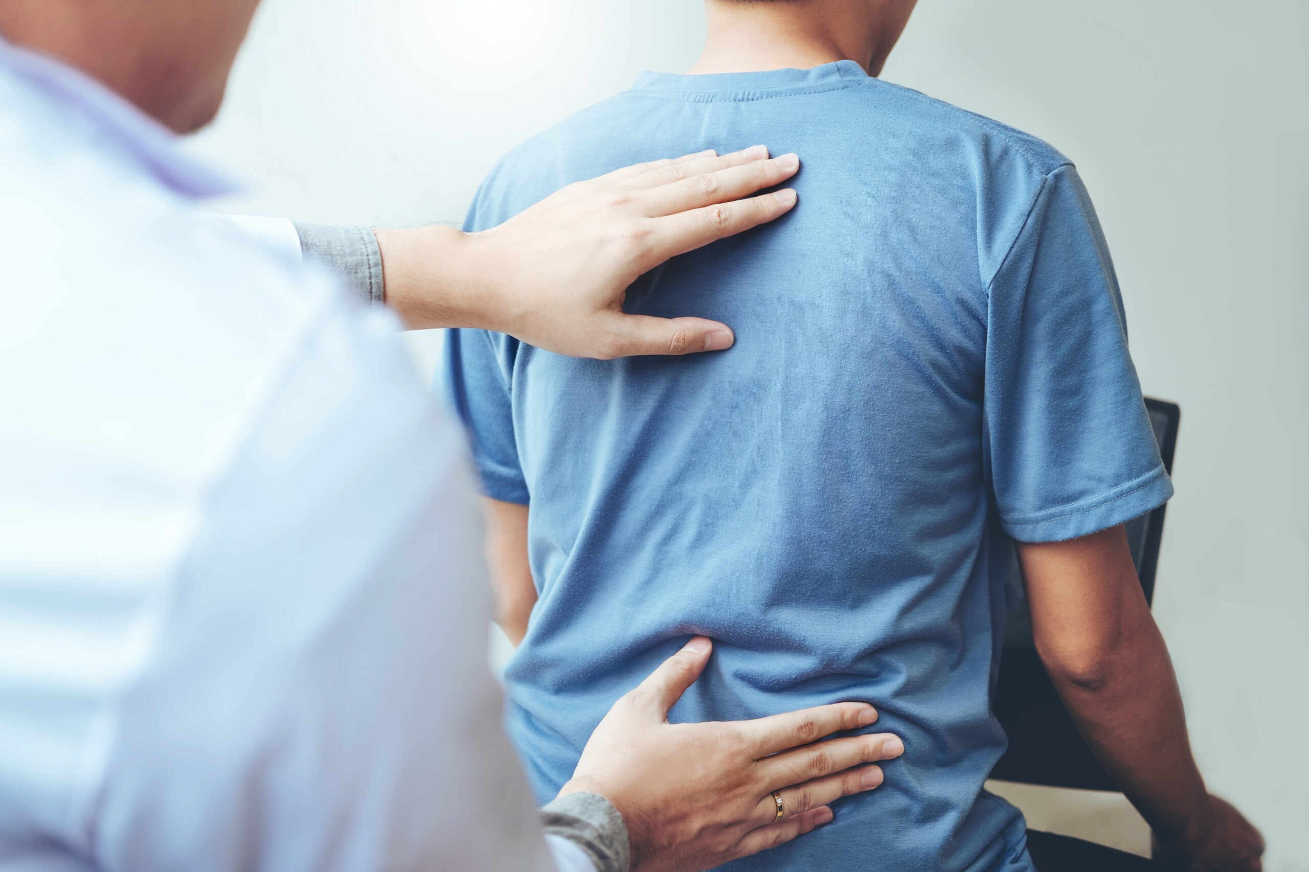 Doctor consulting with patient for back problems