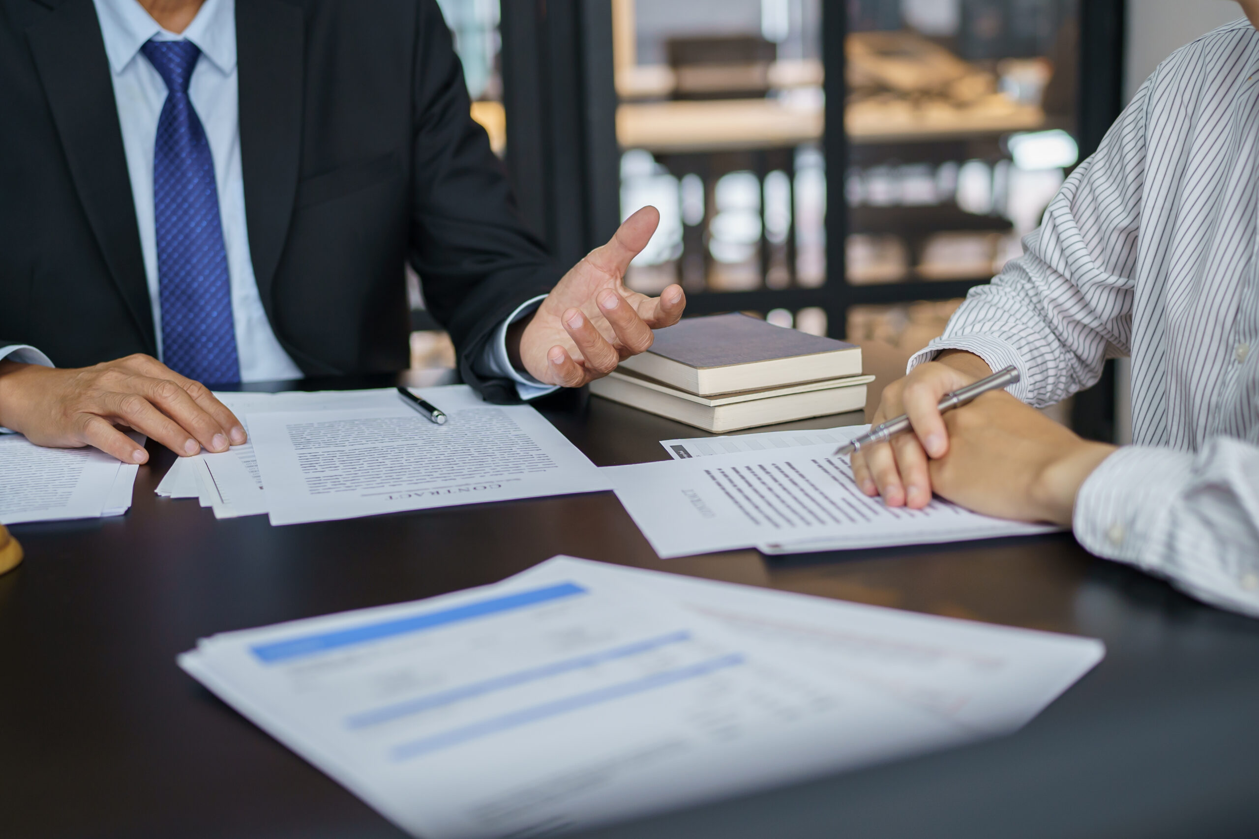 Lawyer Legal counsel presents to the client a signed contract wi Lawyer Legal counsel presents to the client a signed contract