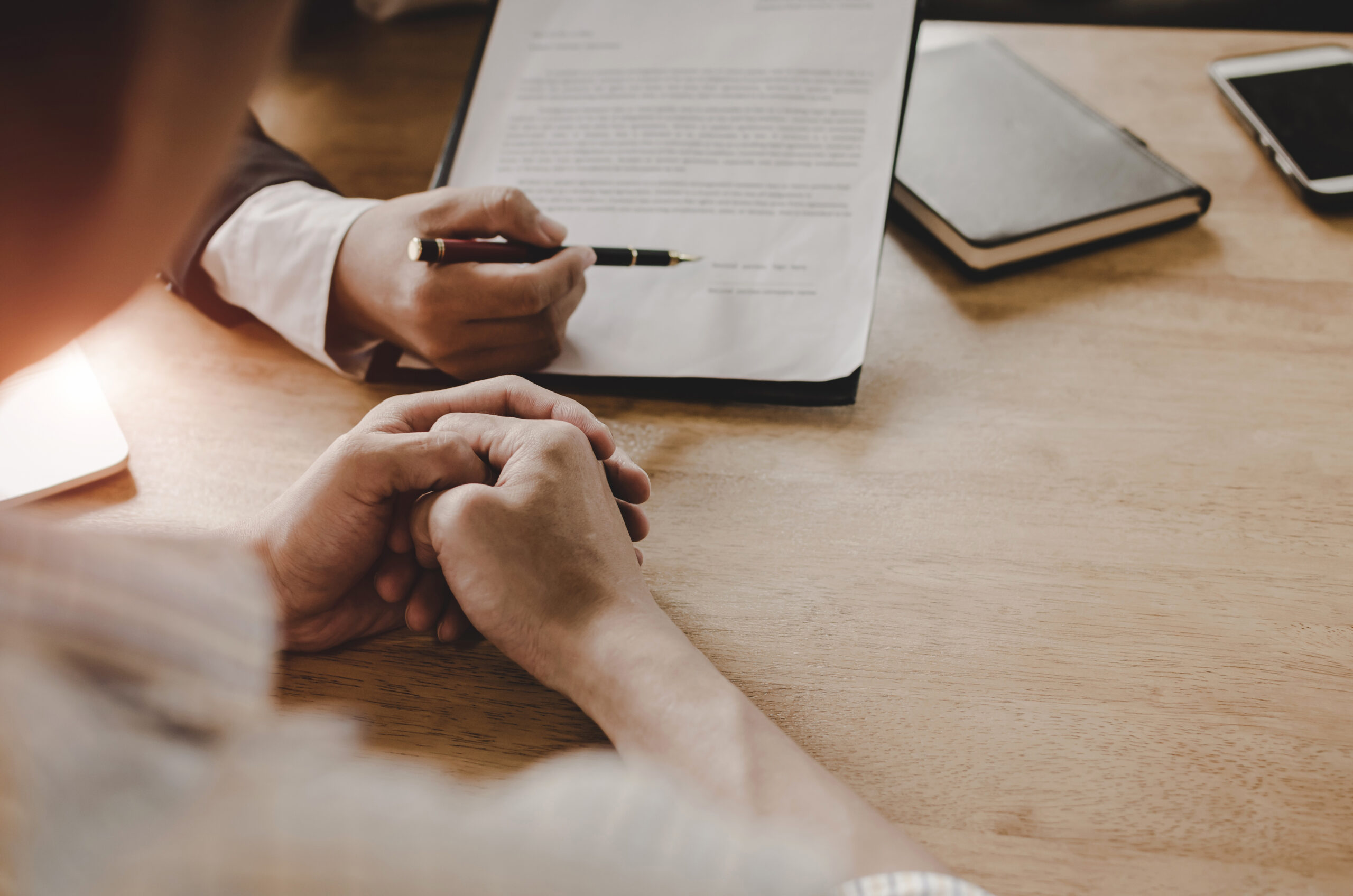 legal consultants, notary or justice lawyer discussing contract document and notebook on desk with client customer in courtroom office, business, justice law, insurance,  legal service concept client reviewing legal paperwork with attorney