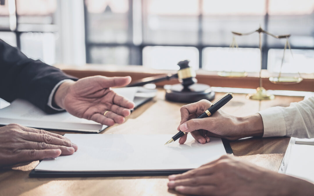 attorney having a consultation with client to discuss paperwork