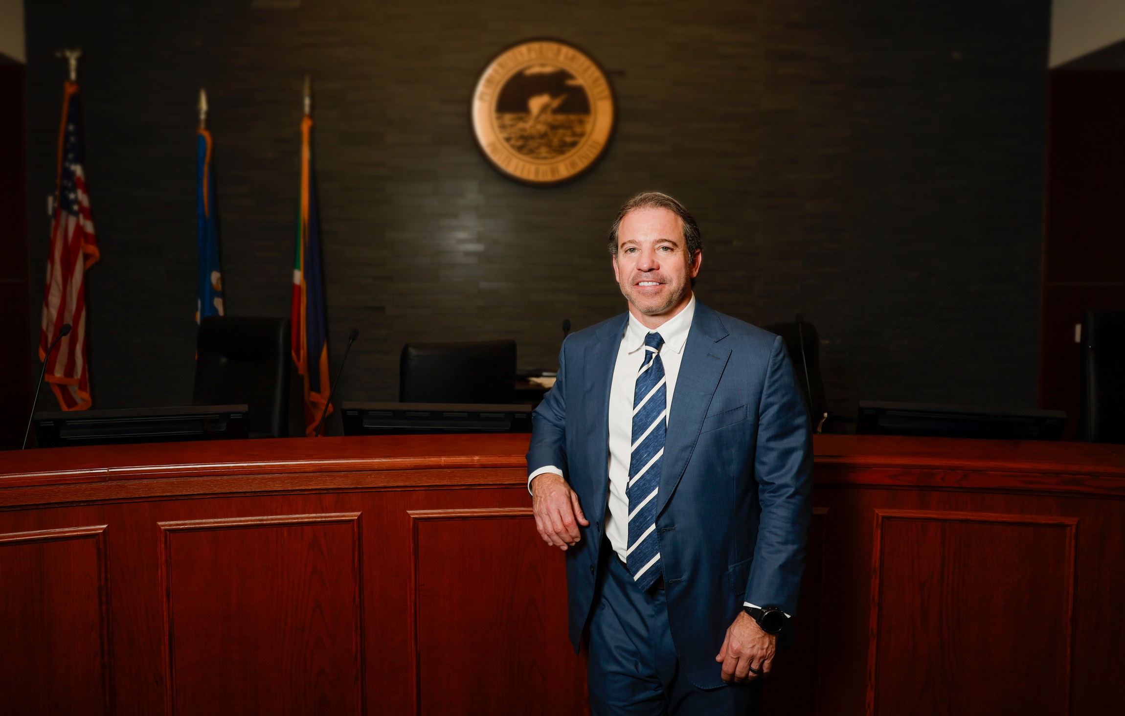 Image 1_edited A man in a suit standing in a courtroom