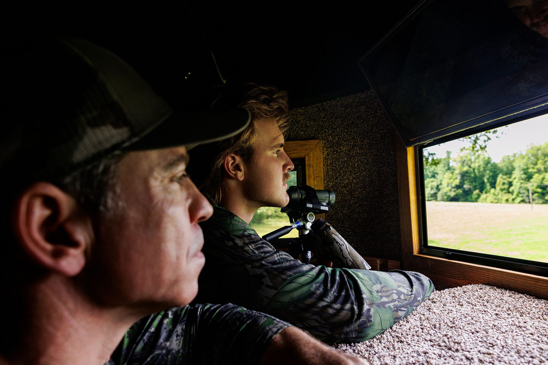 TCM NIL Campaign Landing Page_Image 3 John Carmouche & Whit Weeks in a hunting stand