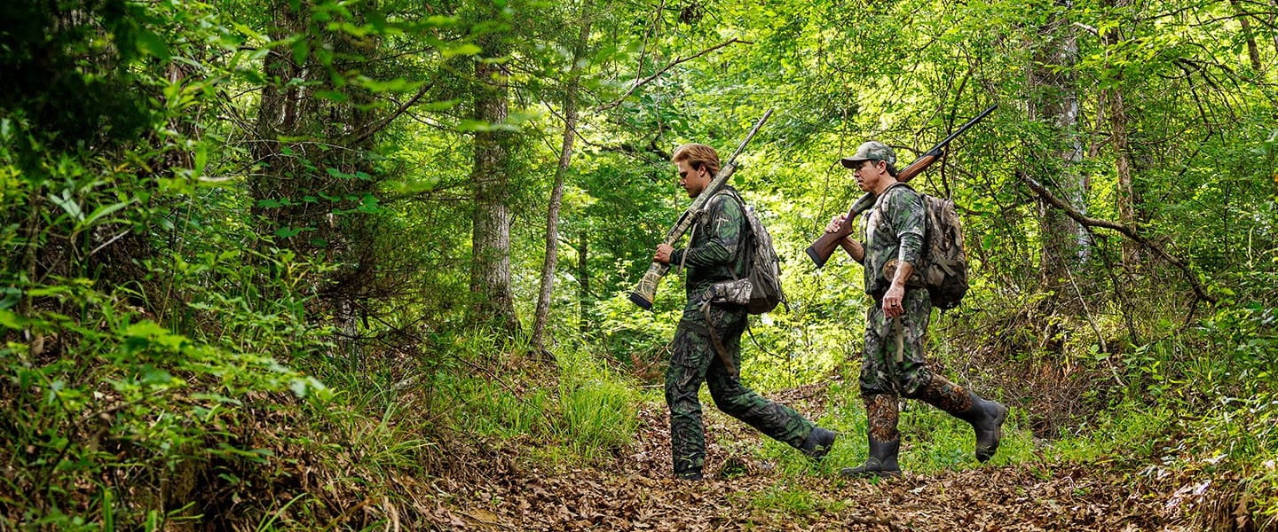 John Carmouche and Whit Weeks walking through the forest