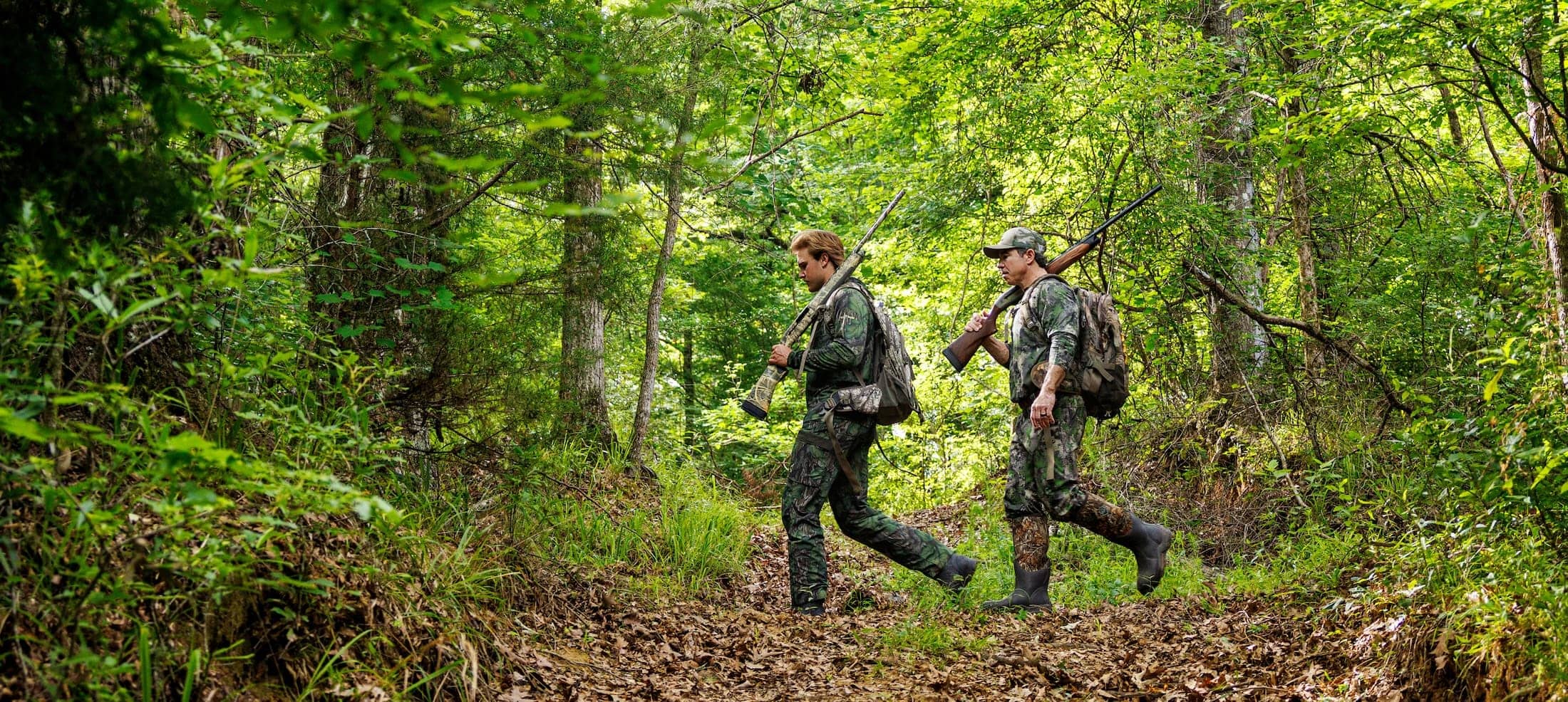 John Carmouche and Whit Weeks walking through the forest